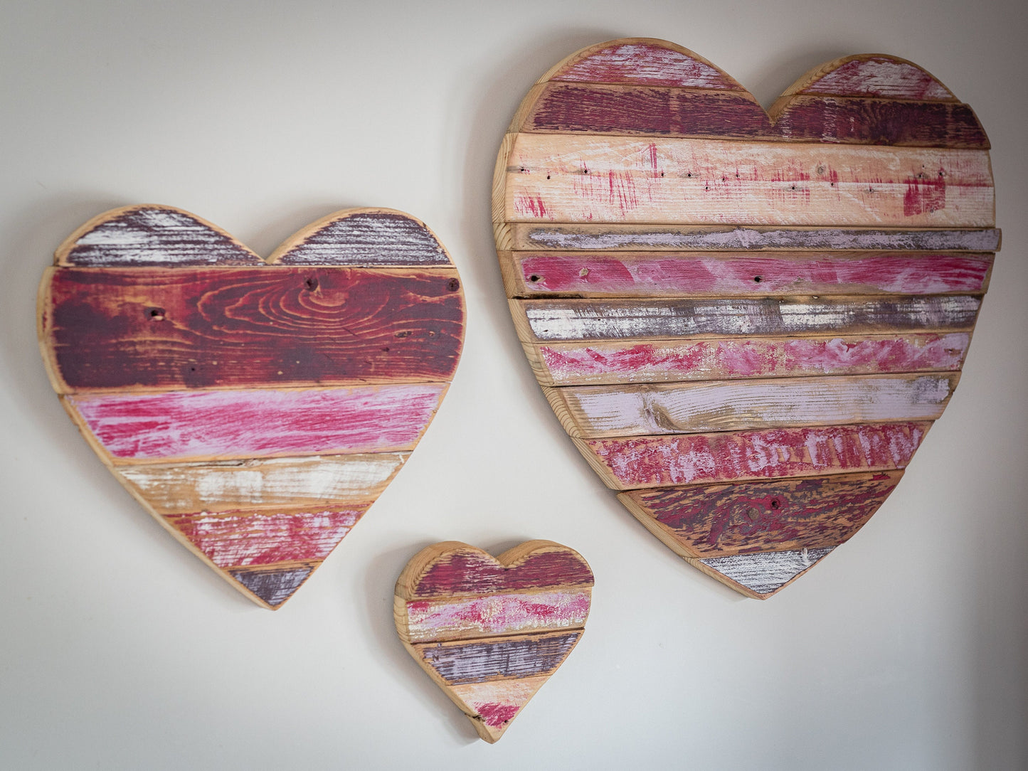 Rustic, painted, farmhouse style wooden hearts, for home decor or shop display.