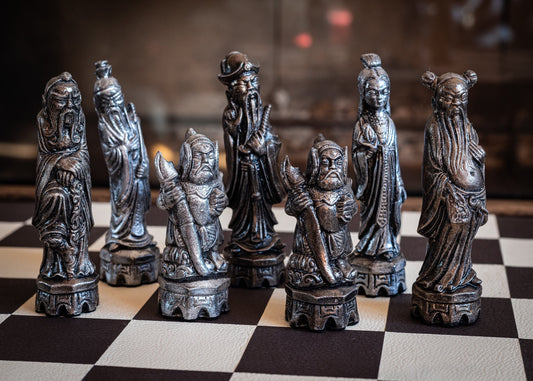 Chess set, Chinese design in a bronze and pewter effect. BOARD NOT INCULDED