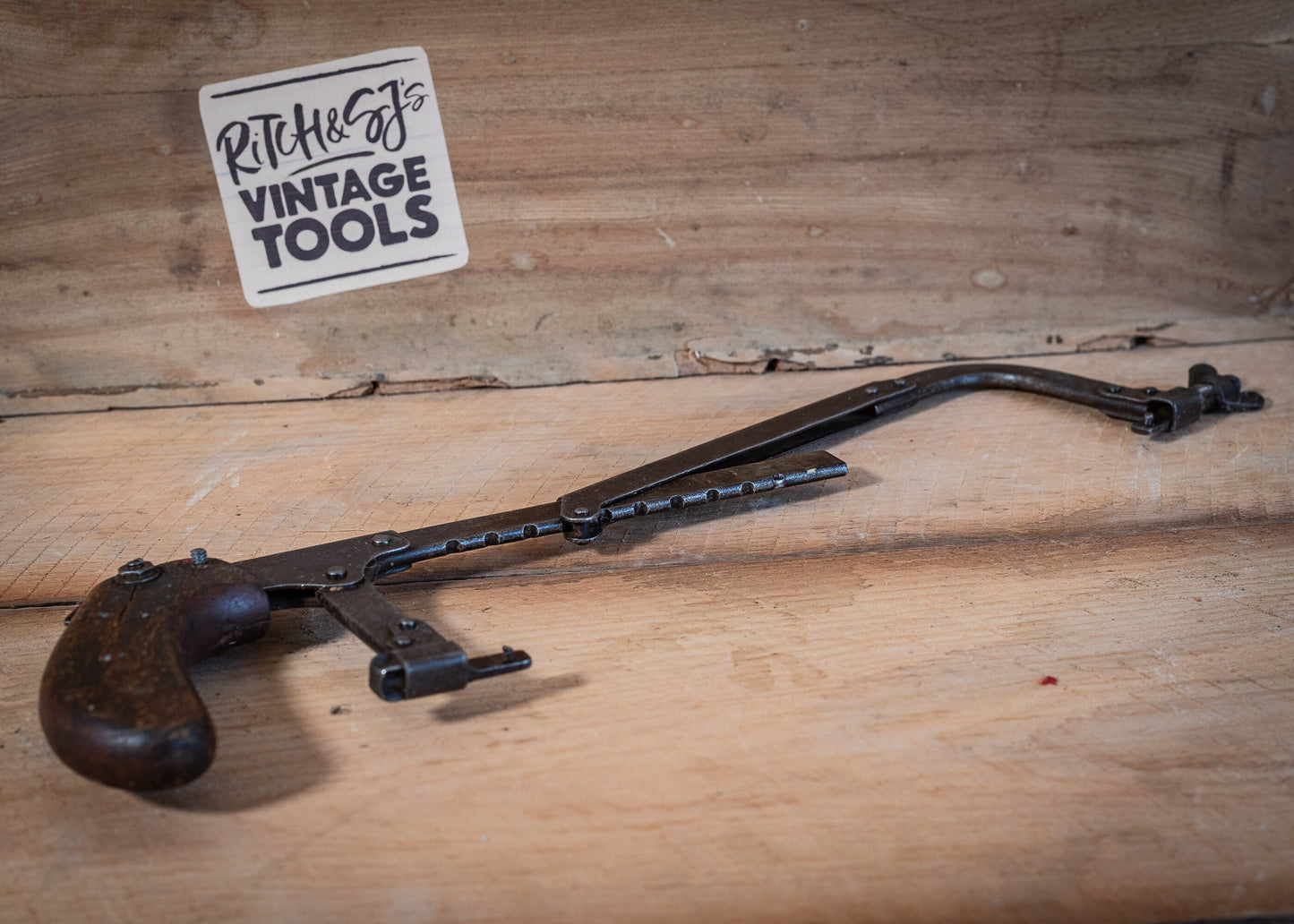 Vintage adjustable length hacksaw, with pistol style, wooden grip.