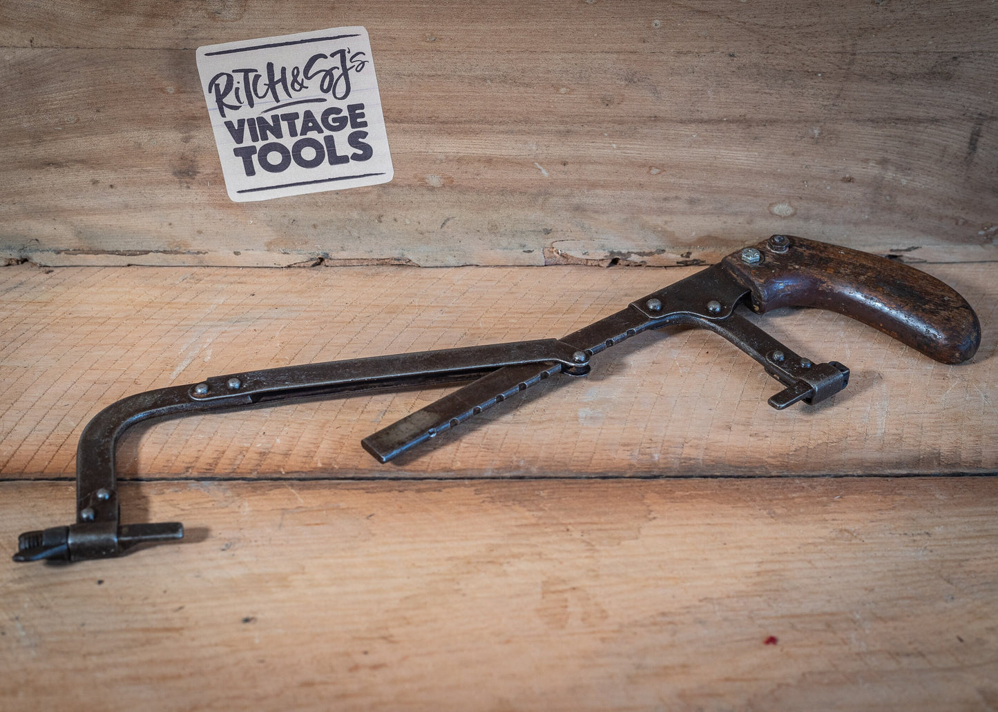 Vintage adjustable length hacksaw, with pistol style, wooden grip.