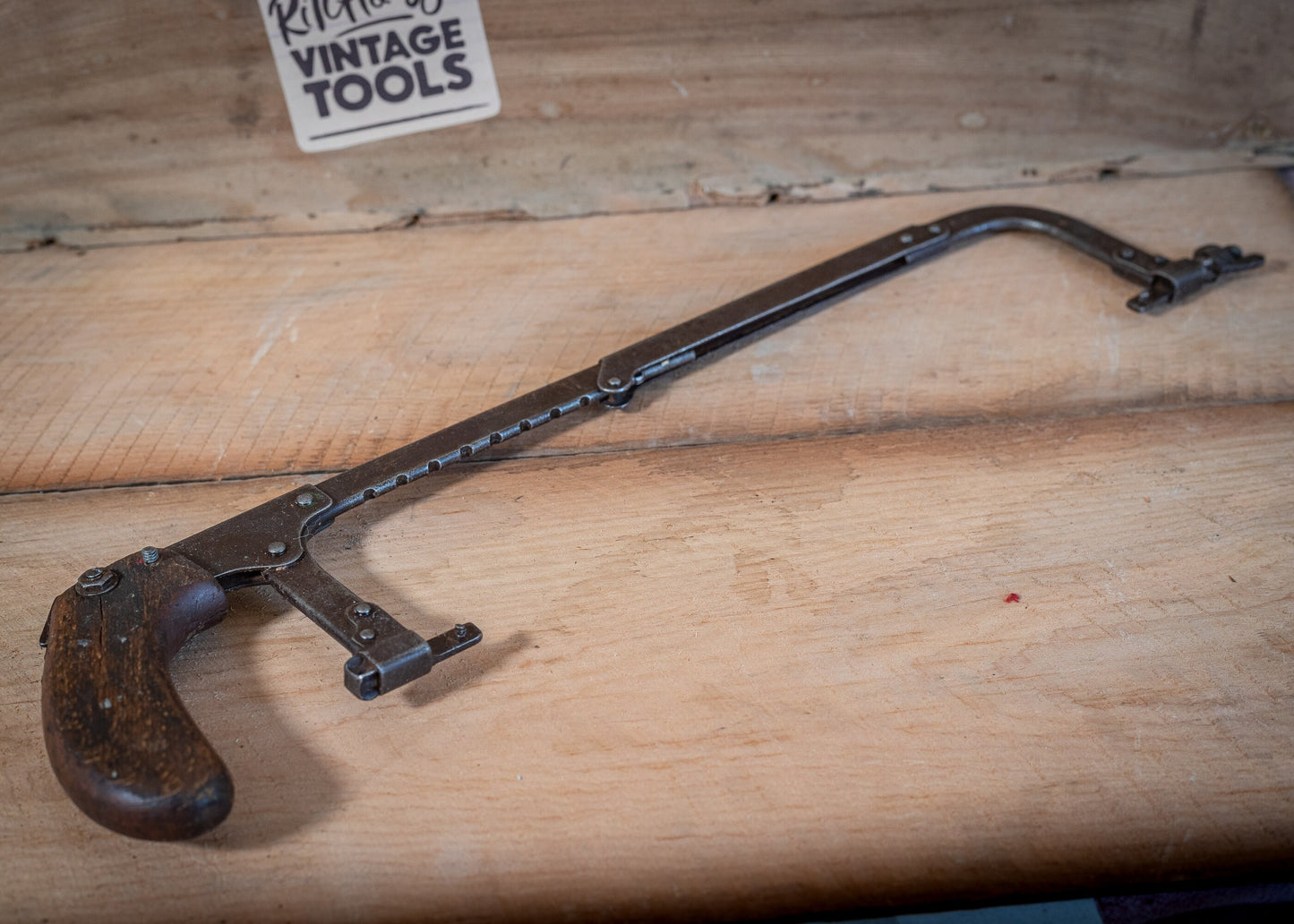 Vintage adjustable length hacksaw, with pistol style, wooden grip.