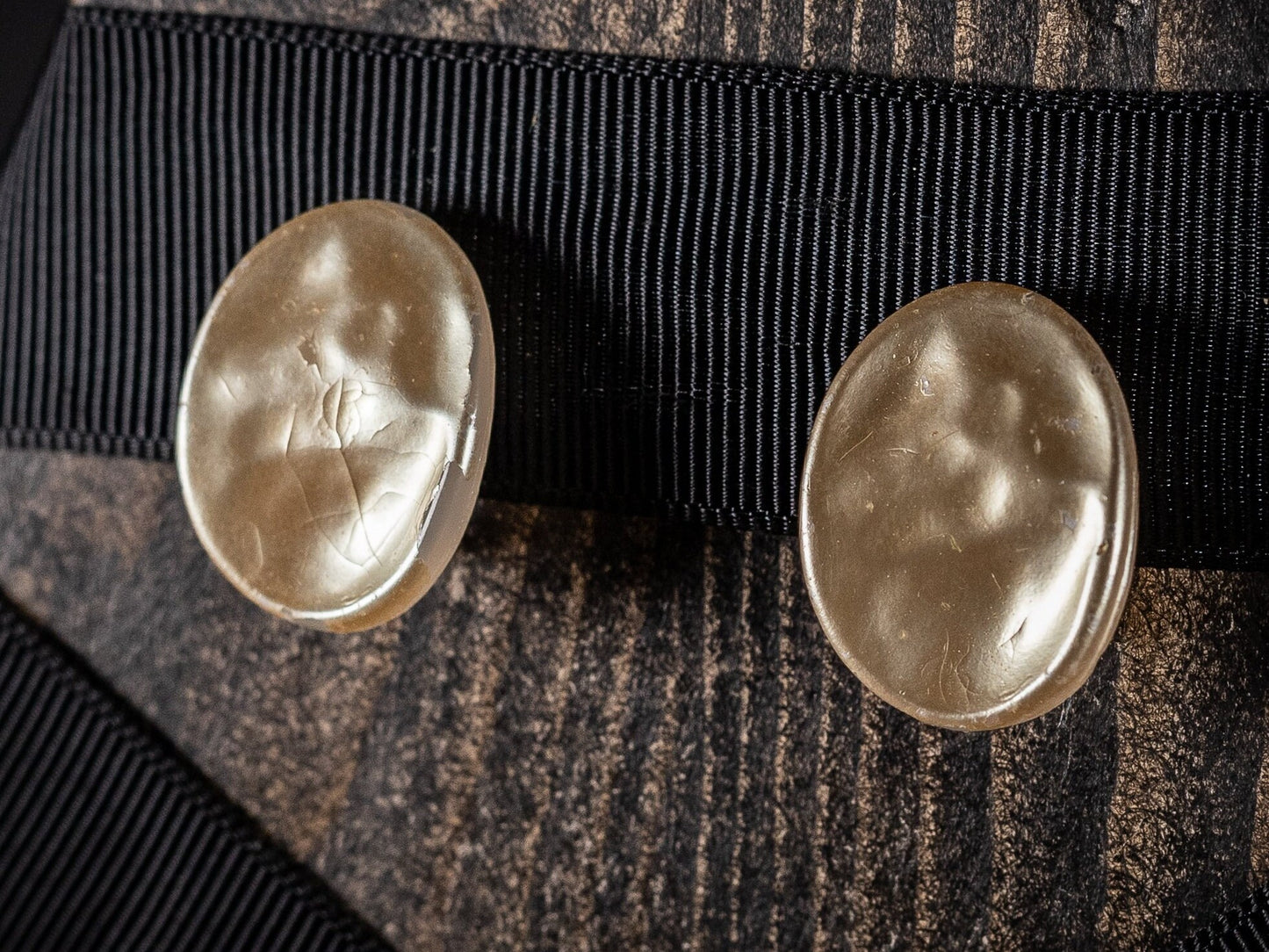 Two pairs of vintage clip on earrings, faux Mother of Pearl ovals and a gold metal and white wave style