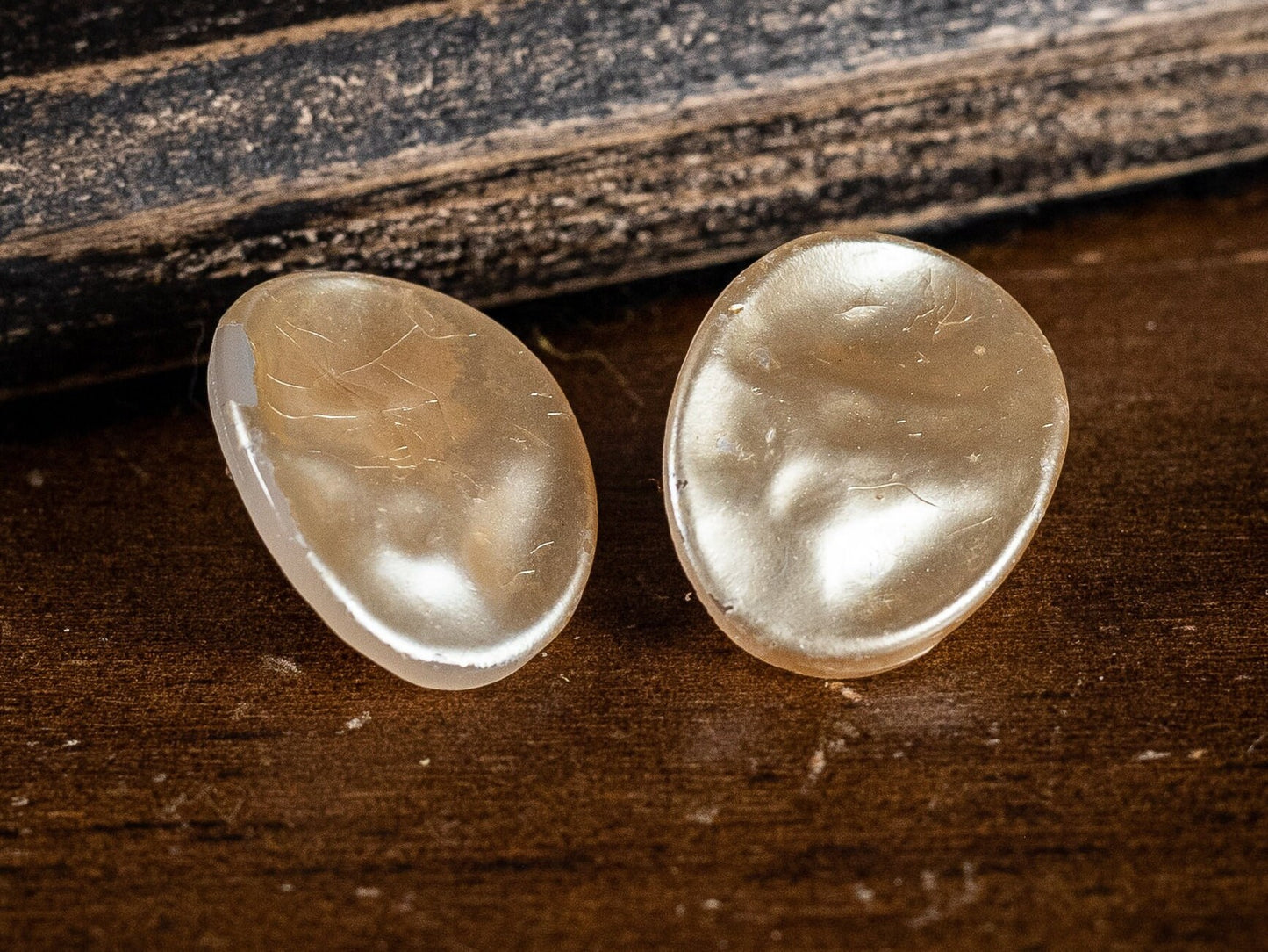 Two pairs of vintage clip on earrings, faux Mother of Pearl ovals and a gold metal and white wave style