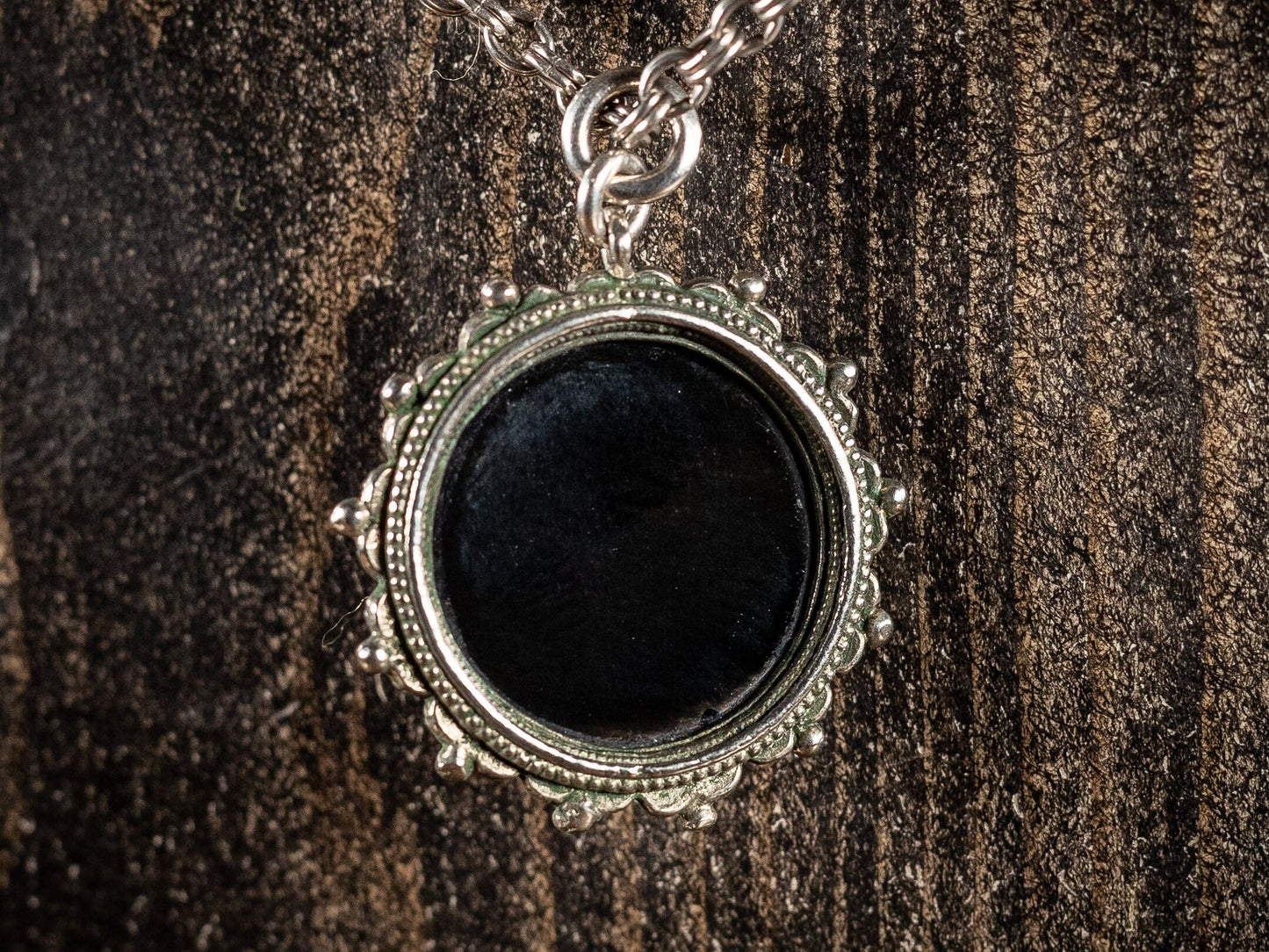 Silver necklace with round black gemstone pendant