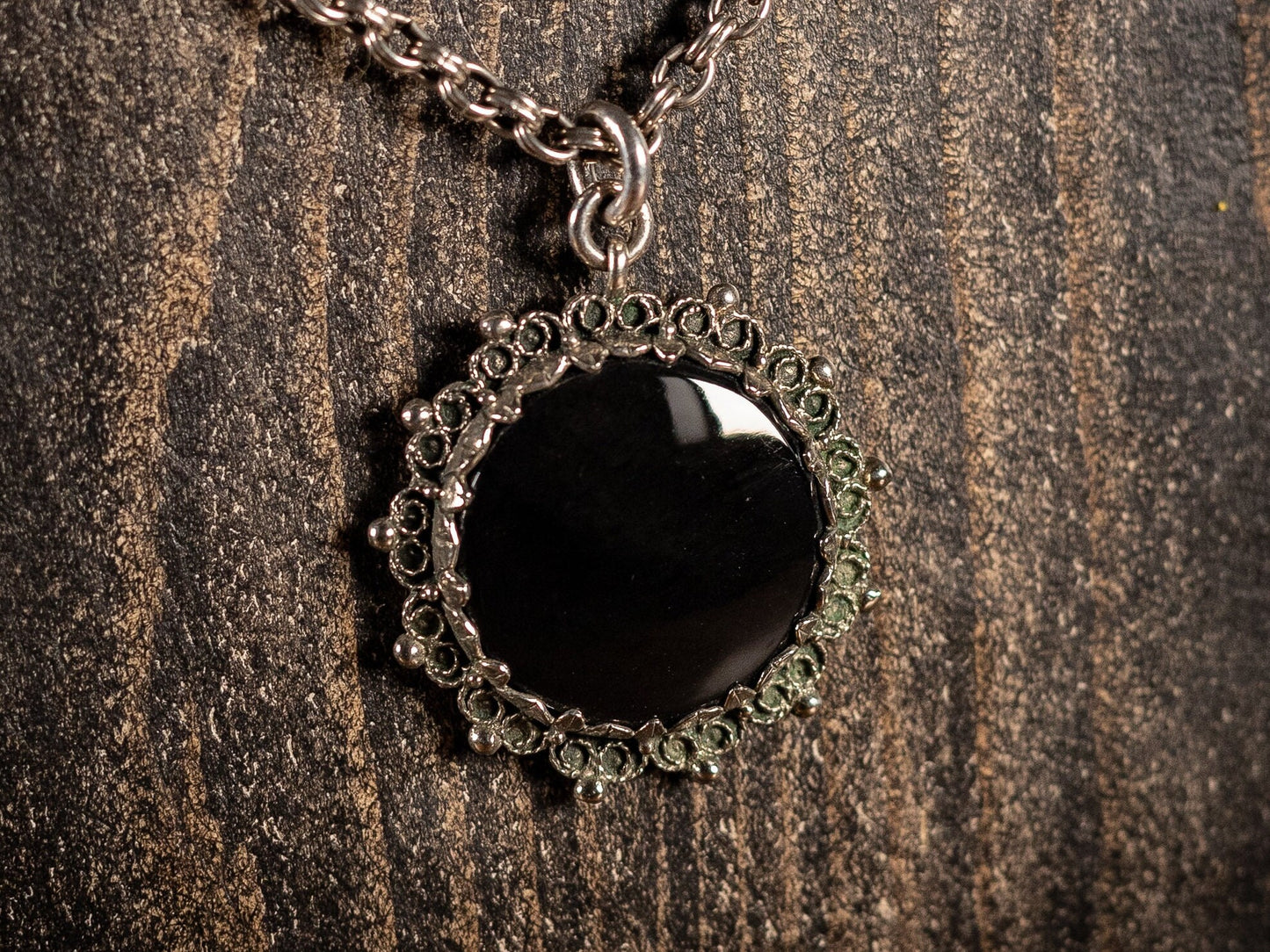 Silver necklace with round black gemstone pendant