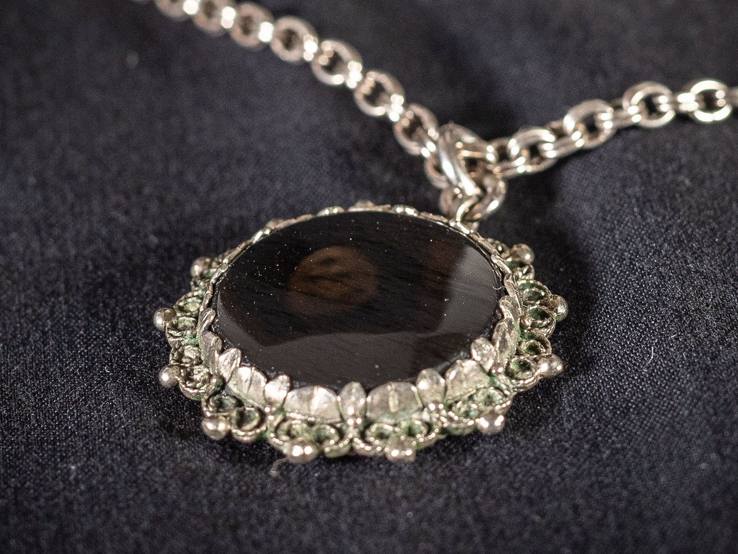 Silver necklace with round black gemstone pendant