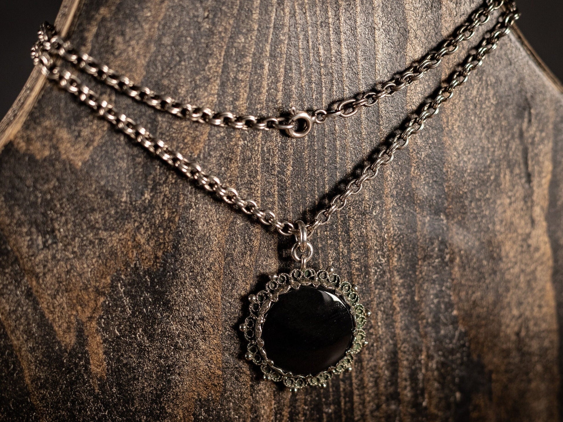 Silver necklace with round black gemstone pendant