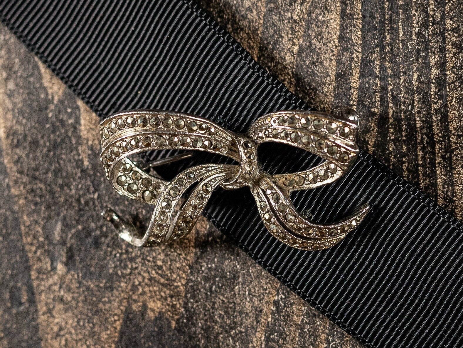 Sparkling vintage marcasite and white metal bow booch or lapel pin.