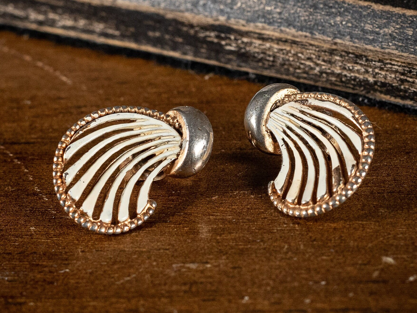 Two pairs of vintage clip on earrings, faux Mother of Pearl ovals and a gold metal and white wave style