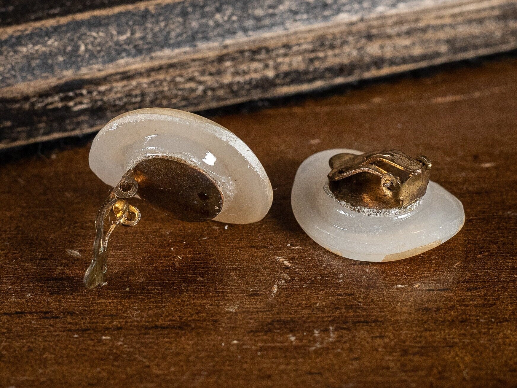 Two pairs of vintage clip on earrings, faux Mother of Pearl ovals and a gold metal and white wave style