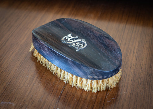 Monogrammed wooden clothes brush, with natural bristles.