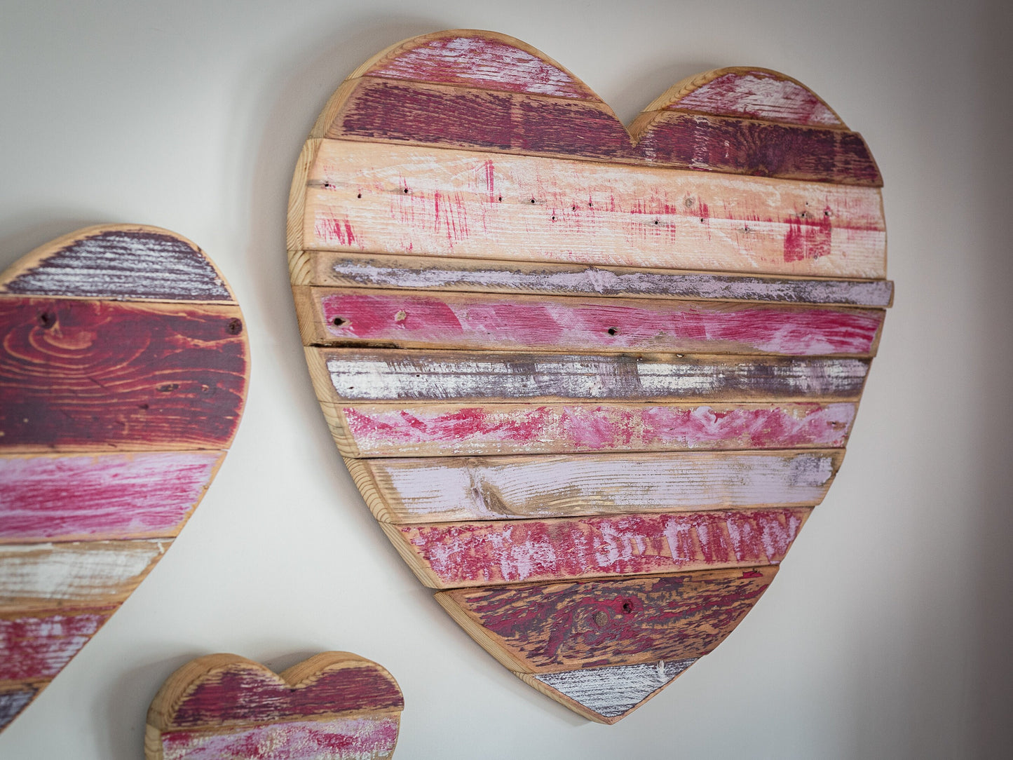 Rustic, painted, farmhouse style wooden hearts, for home decor or shop display.