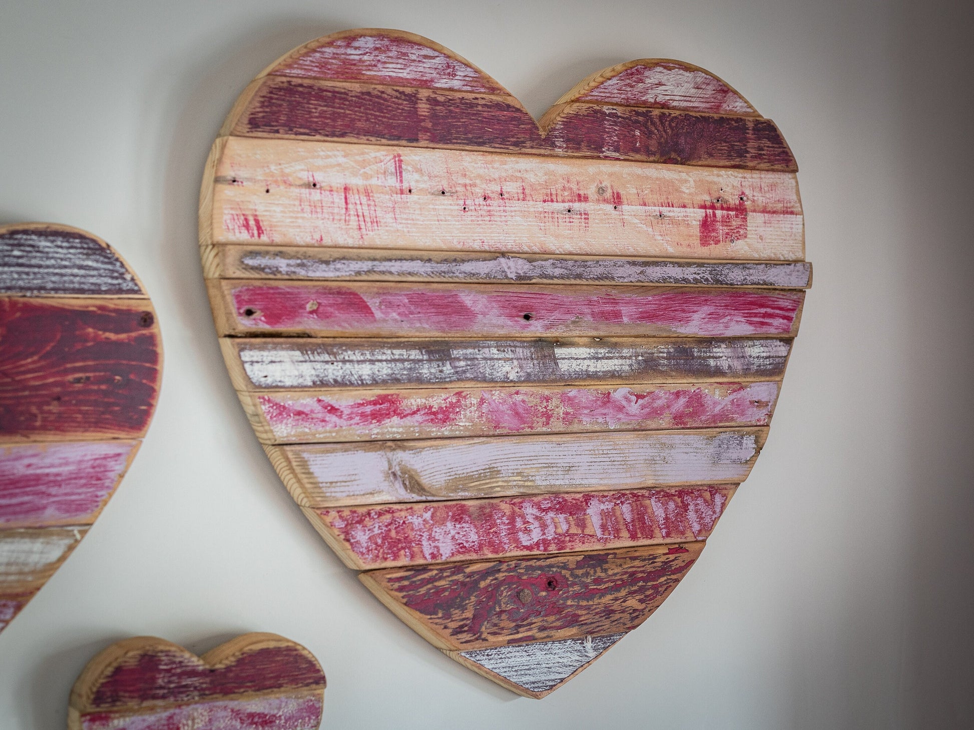 Rustic, painted, farmhouse style wooden hearts, for home decor or shop display.