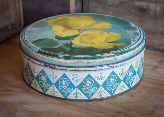 Vintage round confectionery or biscuit tin, with yellow rose design, antique, collectable and rare tins.