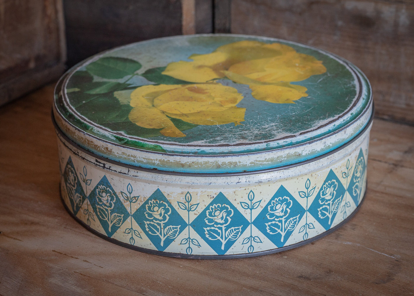 Vintage round confectionery or biscuit tin, with yellow rose design, antique, collectable and rare tins.