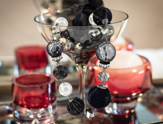 Vintage, black and silver coloured, beaded 80s necklace. With multi sized beads and faux, faceted gems and pearls. Some beads are wrapped in various laces, felt and smaller beads.fastened with two long black ribbons atboths ends.